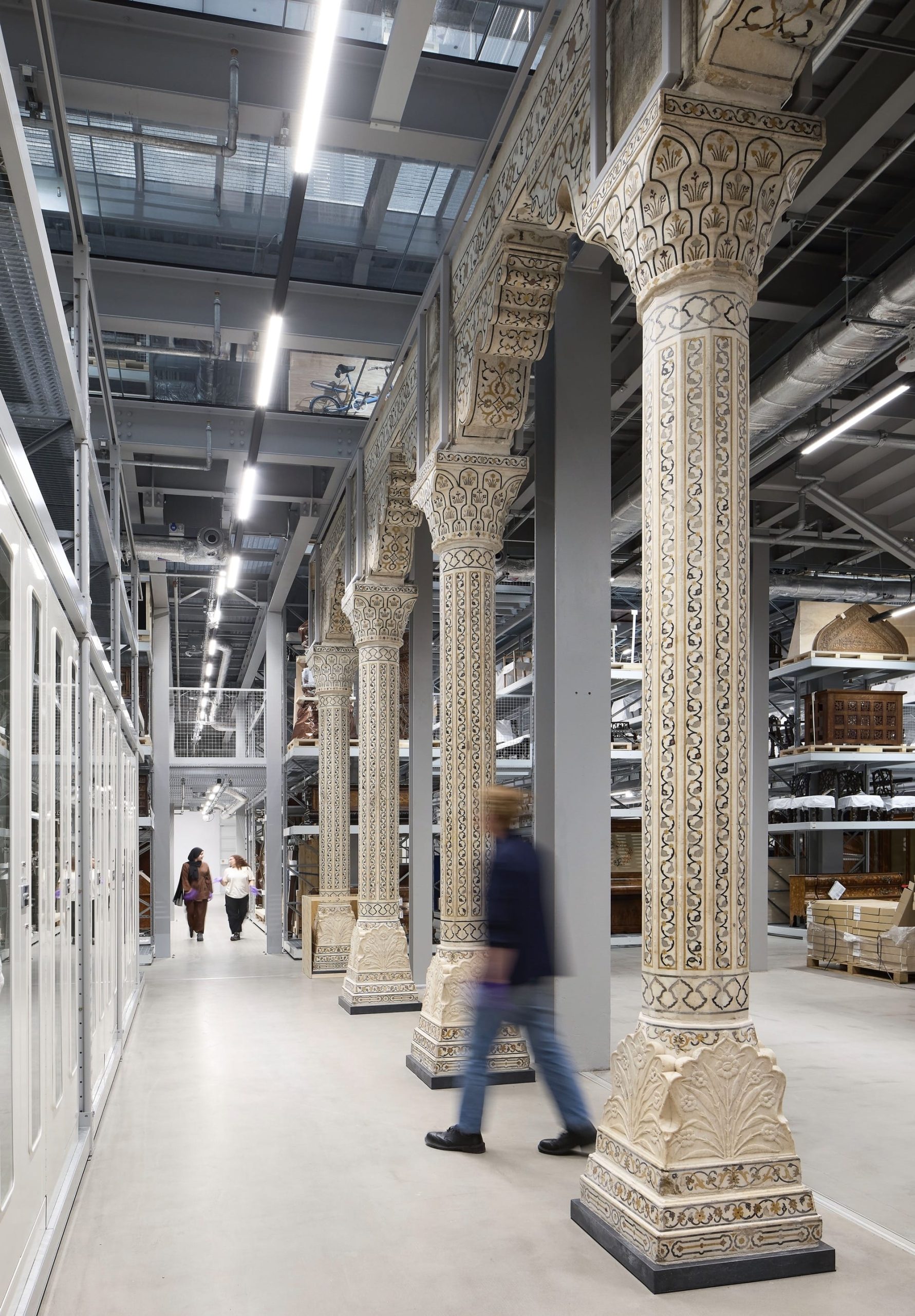 the interior of a contemporary museum collection storehouse with large, ornate columns